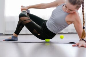 Woman use Myofascial release massage balls on lower back
